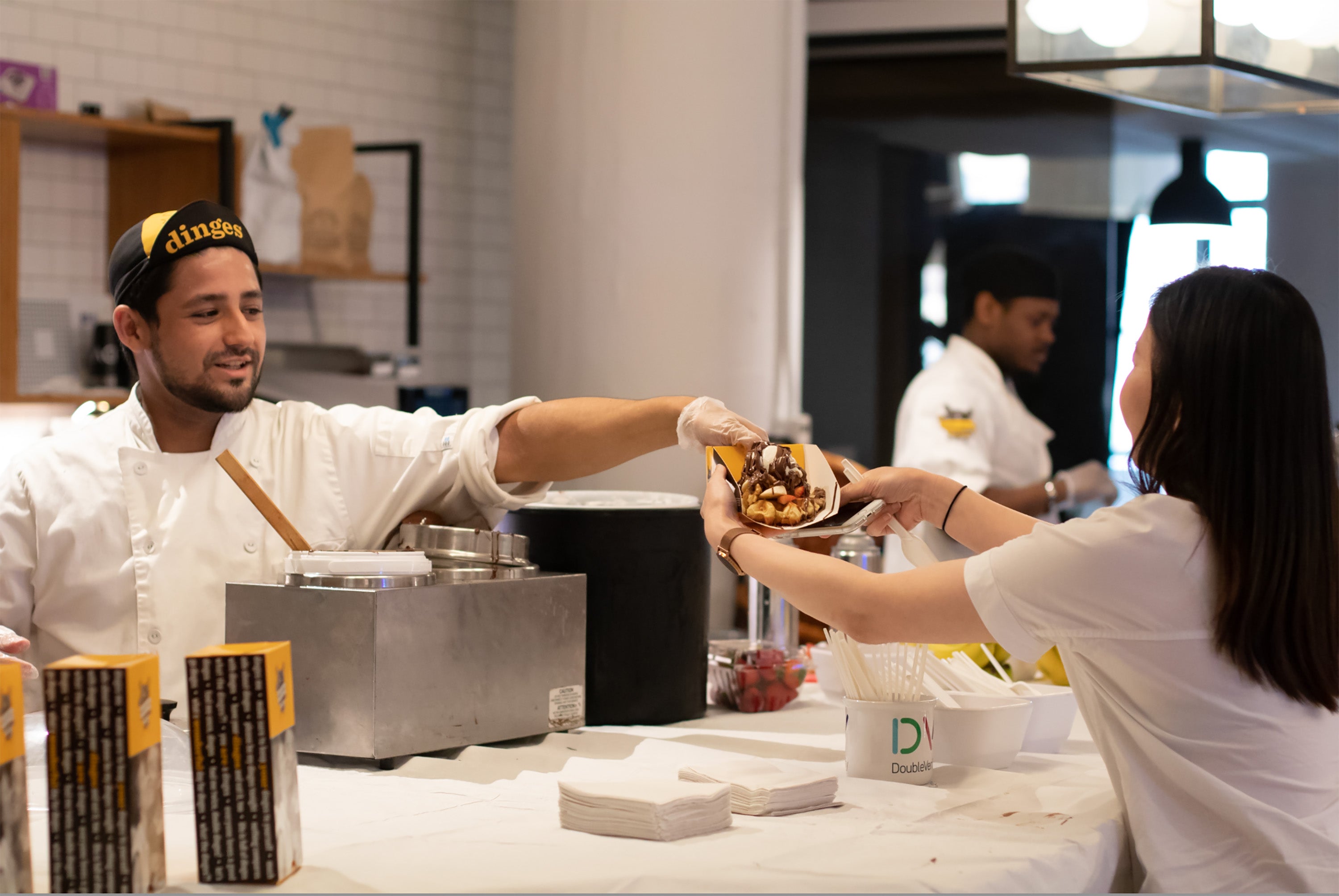 Wafeleur serving waffle during a buffet event