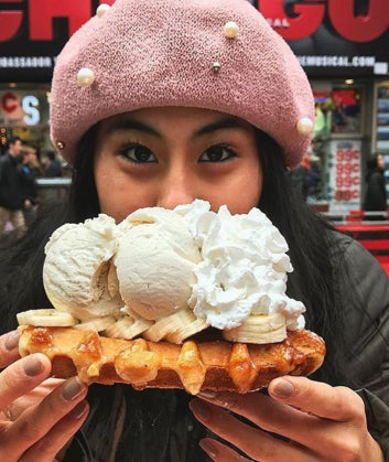 Happy woman about to  enjoy her ice cream waffle
