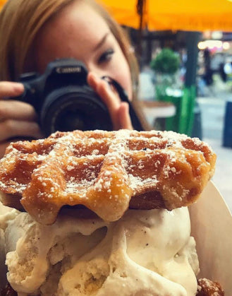 Girl taking a picture  of her waffle