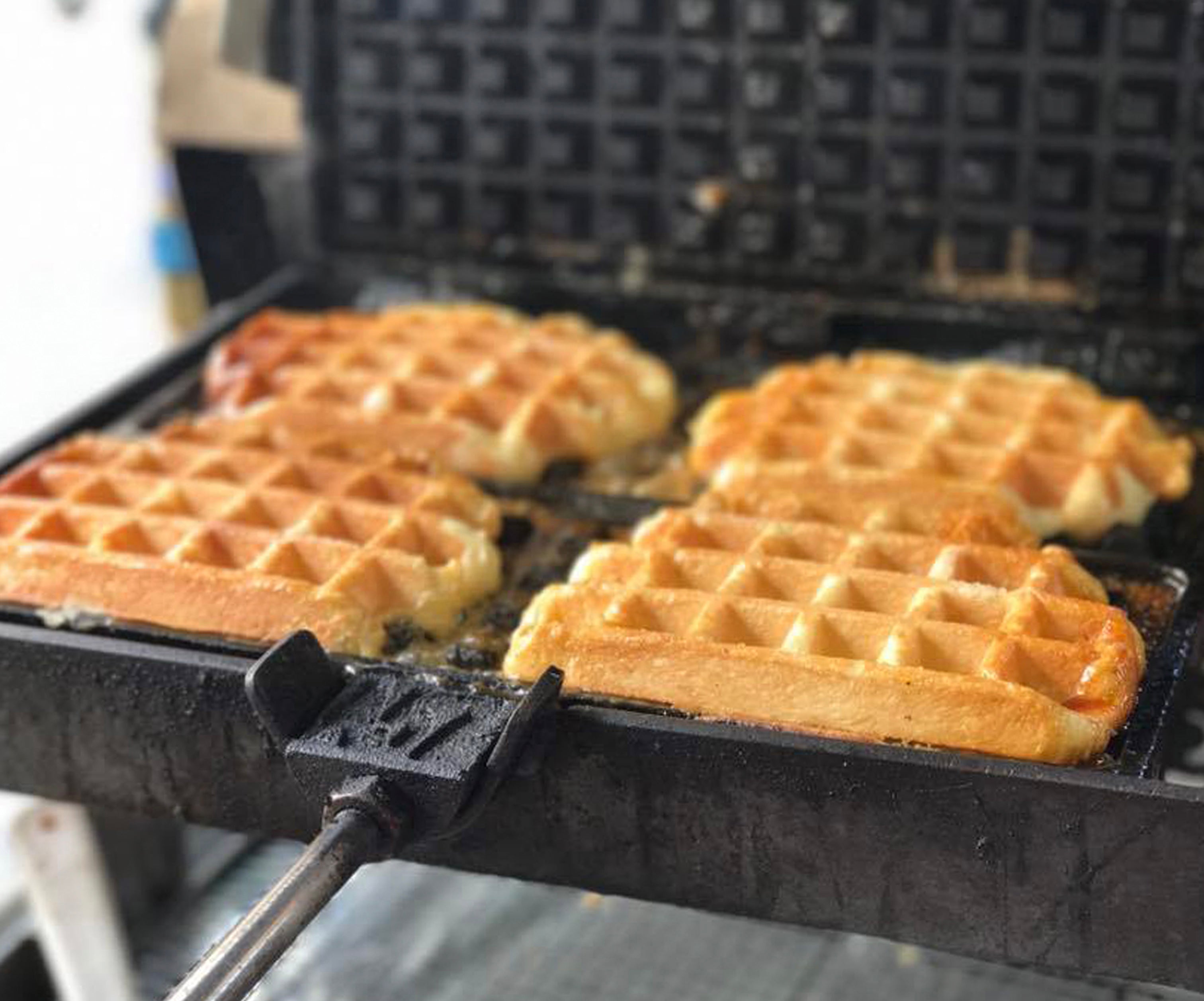 Liège waffle iron open with four delicious waffle in it